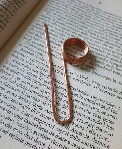 Copper finger ring bookmark holding open a hardcover book