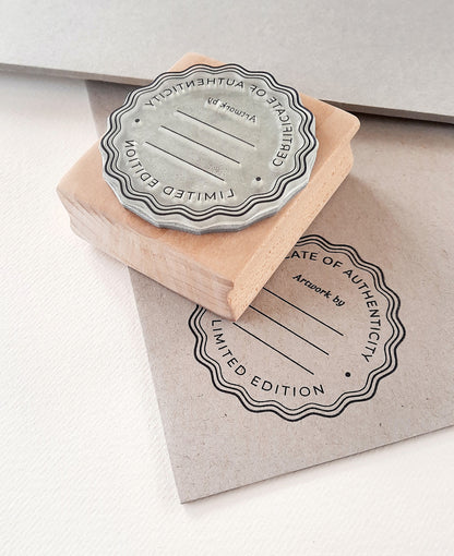 Custom artist seal stamp on certificate paper — limited edition artwork authentication by La Booktique