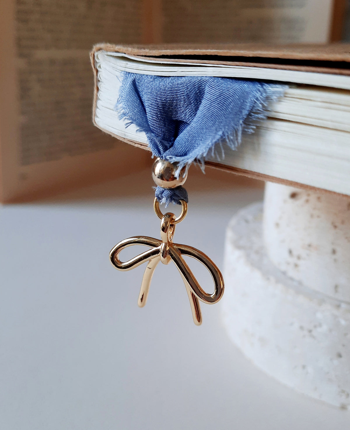 Close-up of handmade silk bookmark with hand-printed calligraphy reading “Life without love is worse than death”