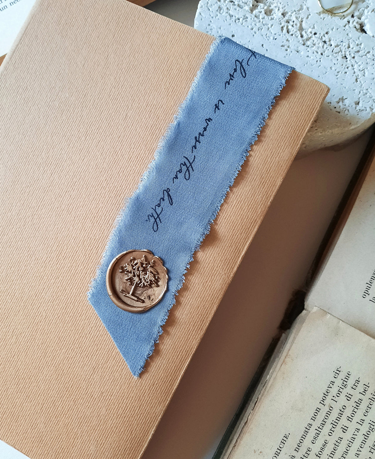 Personalized silk bookmark beautifully packaged in a handmade paper pouch with silk ribbon and wax seal