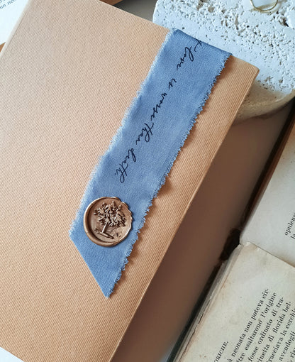 Personalized silk bookmark beautifully packaged in a handmade paper pouch with silk ribbon and wax seal